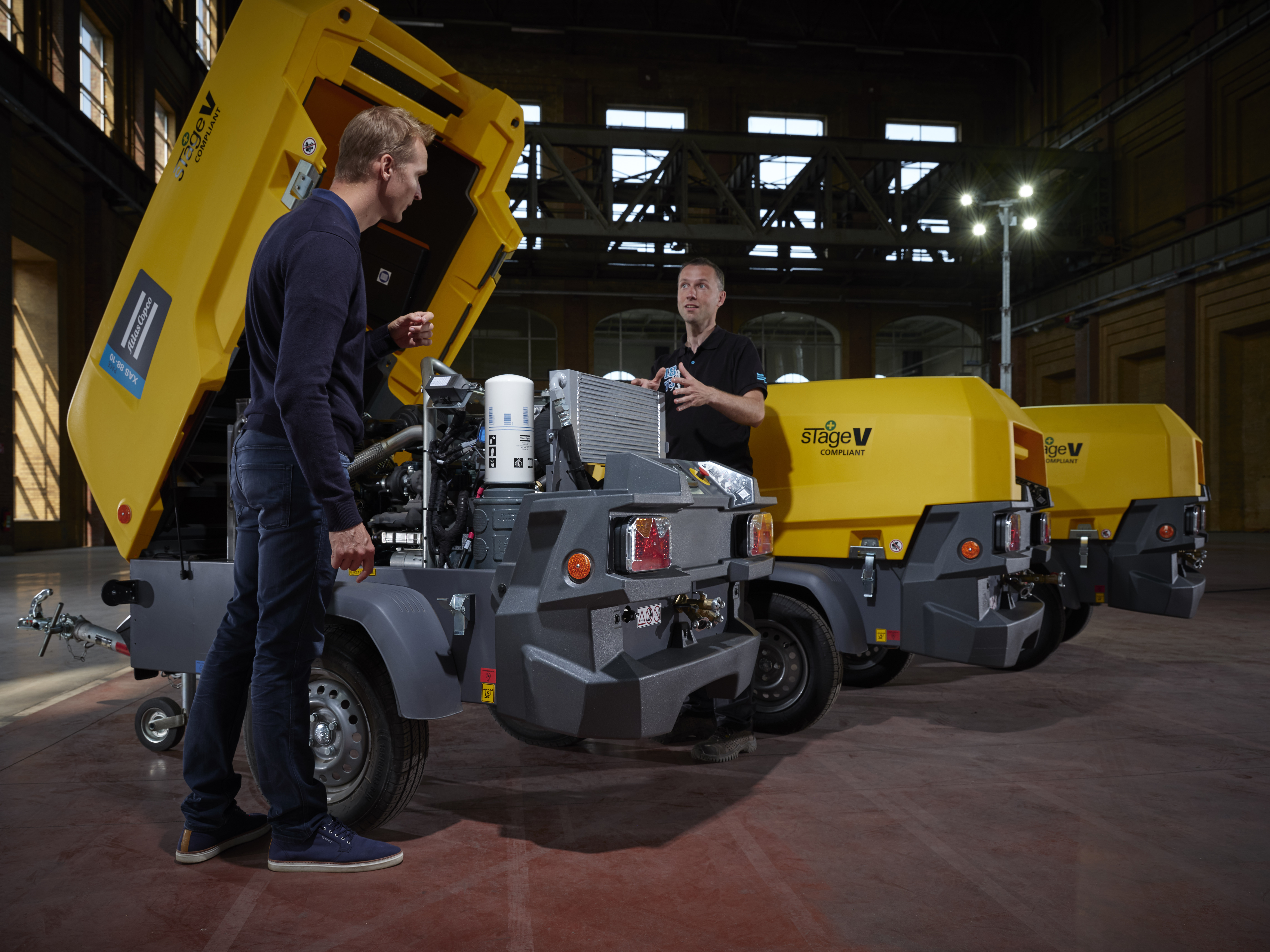 men standing near Small Portable Compressors talking